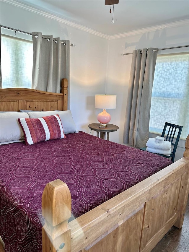 bedroom with wood-type flooring and crown molding