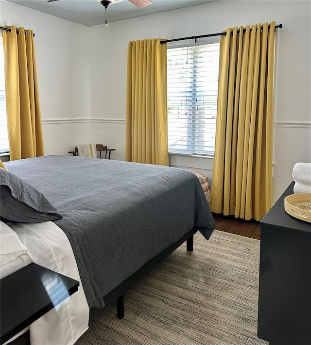 bedroom featuring ceiling fan and dark wood-type flooring