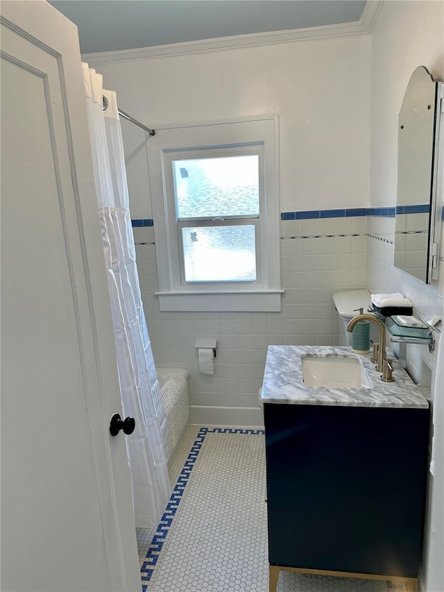 bathroom featuring shower / tub combo, vanity, tile walls, and crown molding