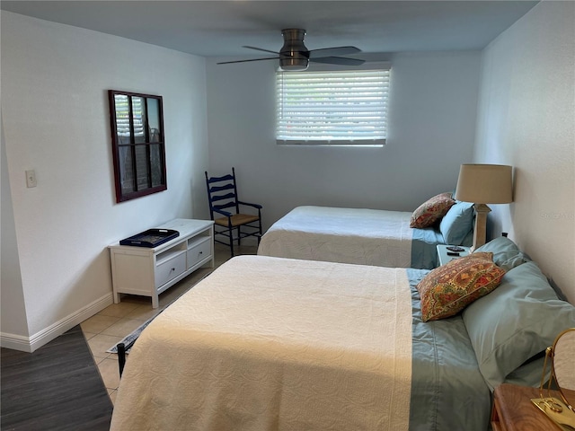 bedroom with multiple windows, ceiling fan, and light hardwood / wood-style flooring