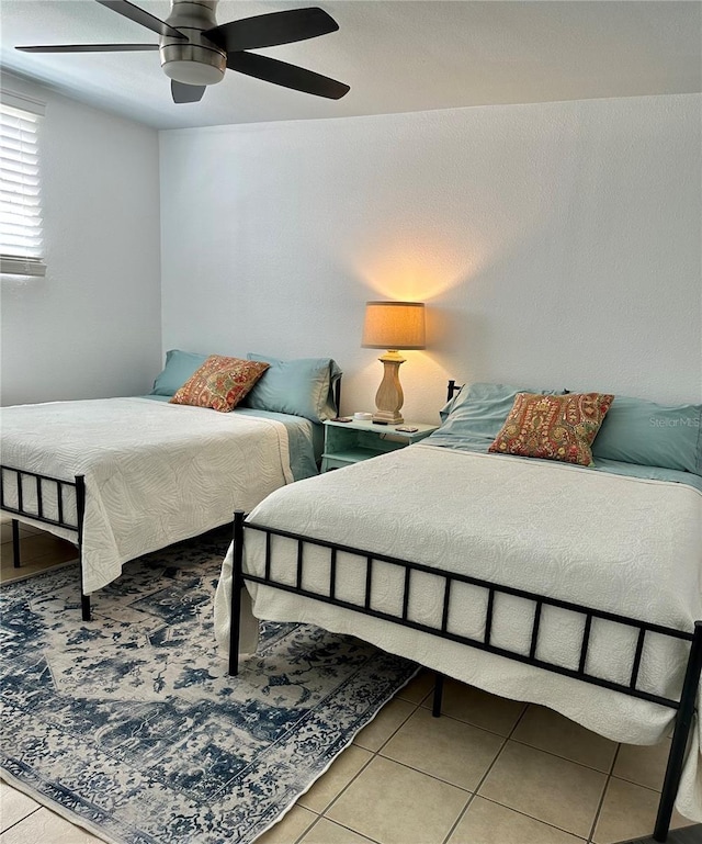 tiled bedroom with ceiling fan