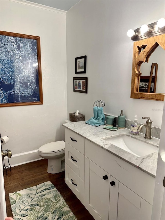 bathroom featuring hardwood / wood-style floors, vanity, and toilet