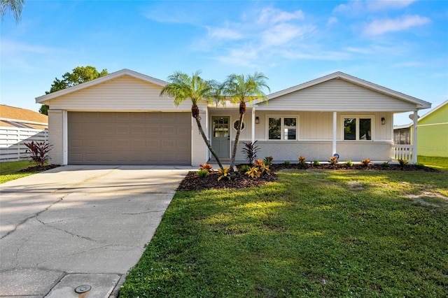 ranch-style home featuring a front lawn, a porch, and a garage