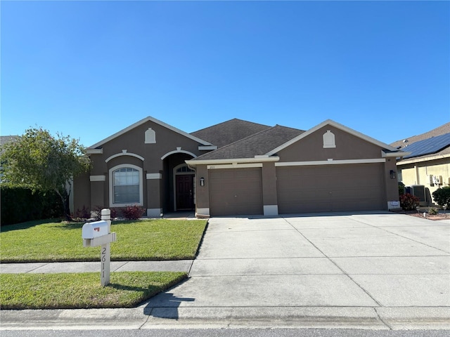 single story home featuring a garage and a front yard