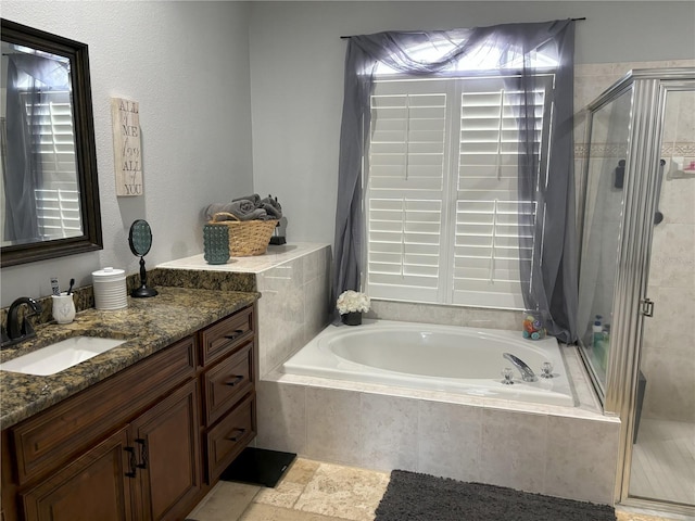 bathroom featuring vanity and separate shower and tub