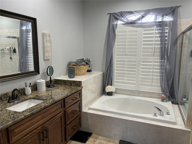 bathroom featuring vanity and separate shower and tub