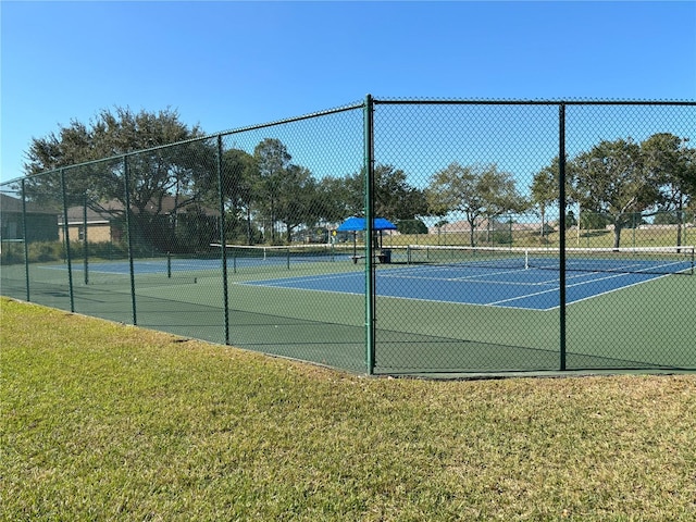 view of sport court featuring a yard