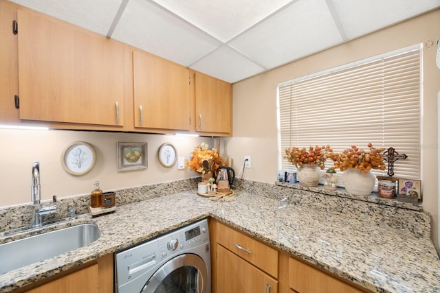 laundry area featuring washer / dryer, cabinets, and sink