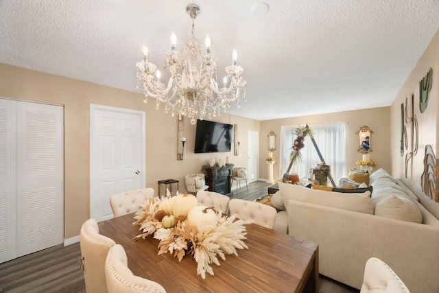 dining room with a textured ceiling, dark hardwood / wood-style floors, and a notable chandelier