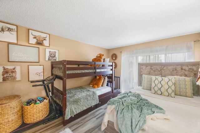 bedroom featuring a textured ceiling and wood-type flooring