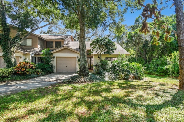 view of front of home featuring a front yard and a garage