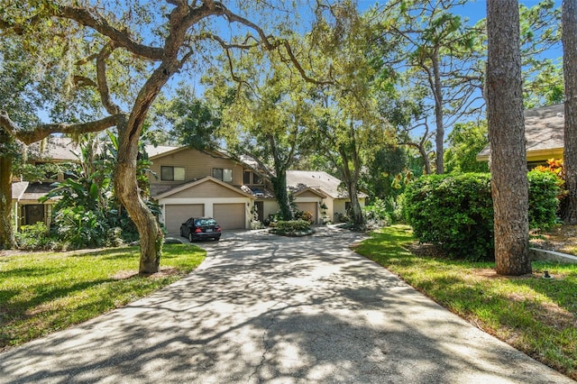 view of front of property featuring a garage and a front yard