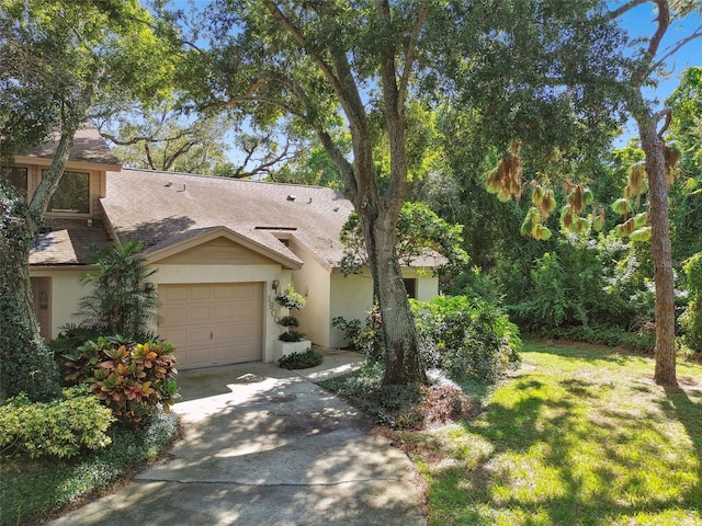 view of front of property with a garage and a front yard