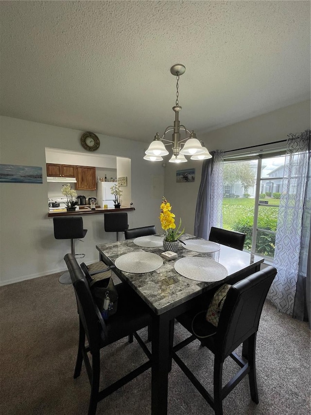 dining room with a textured ceiling, carpet, and a notable chandelier