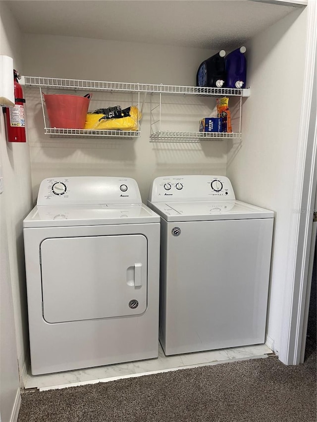 washroom with separate washer and dryer and carpet flooring