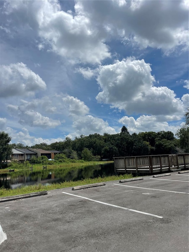 view of vehicle parking with a water view