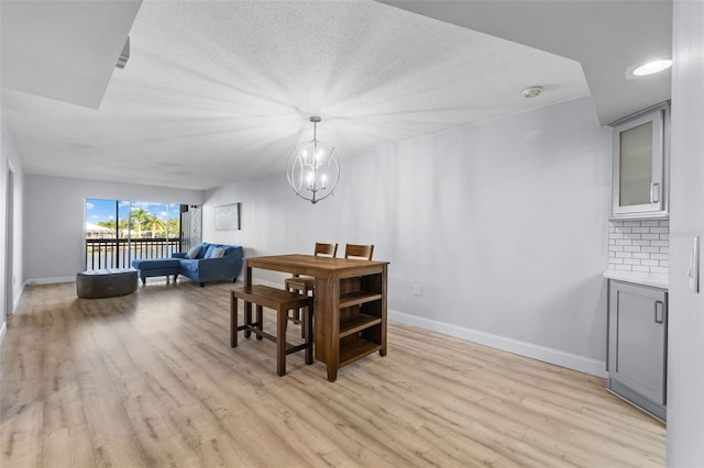 dining room with a chandelier and light hardwood / wood-style flooring