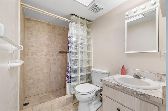 bathroom with vanity, toilet, curtained shower, and tile patterned floors