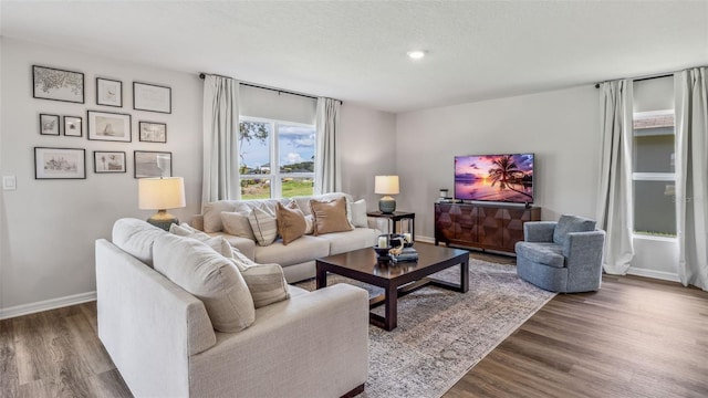 living room with dark hardwood / wood-style floors and a textured ceiling