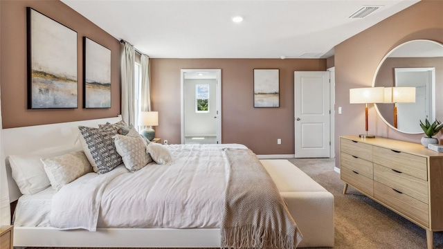 bedroom with light carpet, visible vents, and baseboards