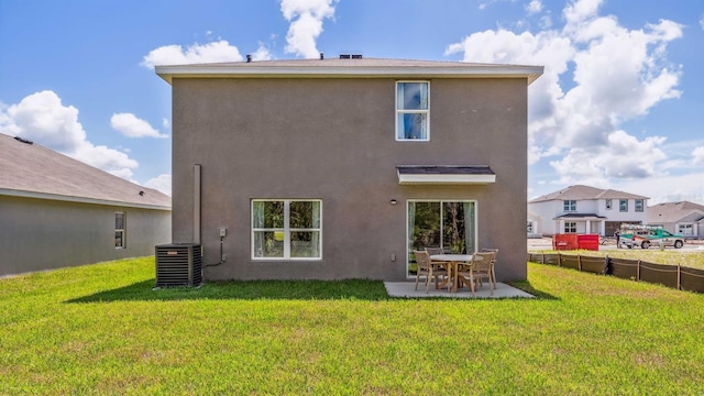 rear view of house featuring stucco siding, a patio, a yard, and cooling unit