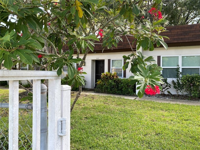 view of exterior entry featuring a yard