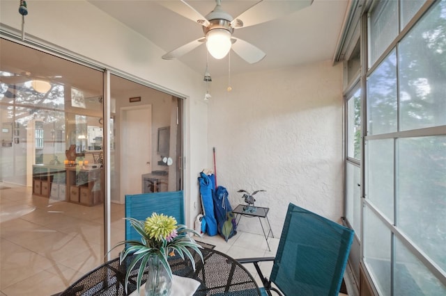 sunroom featuring ceiling fan