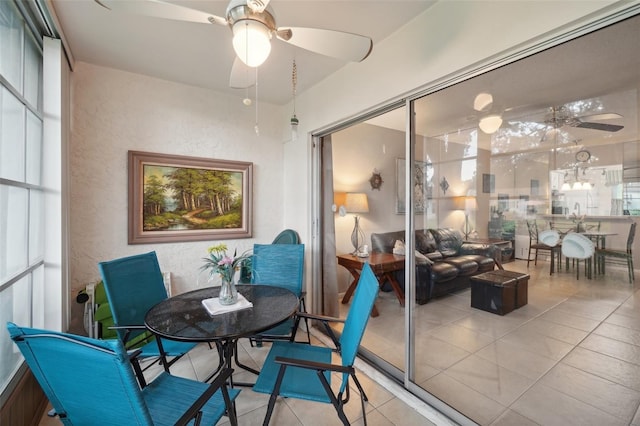 sunroom / solarium featuring ceiling fan