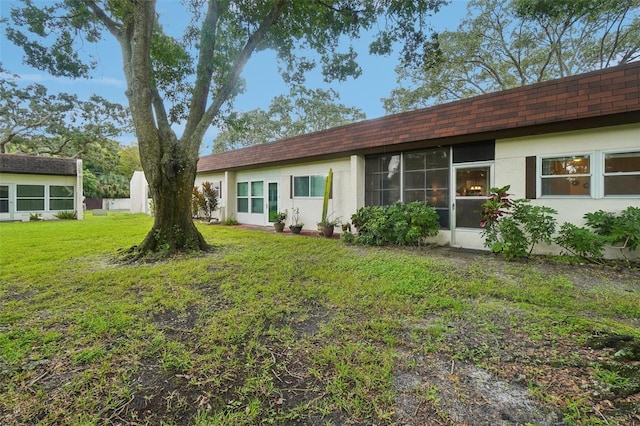 rear view of house with a lawn