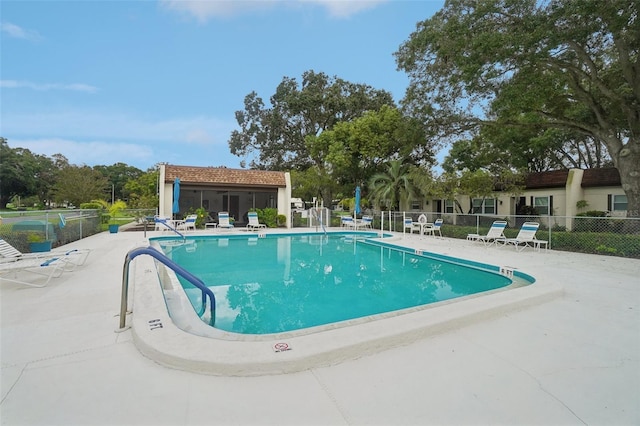 view of pool with an outbuilding and a patio area