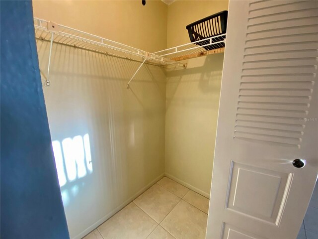 walk in closet with tile patterned flooring