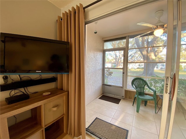 entryway featuring ceiling fan and light tile patterned floors