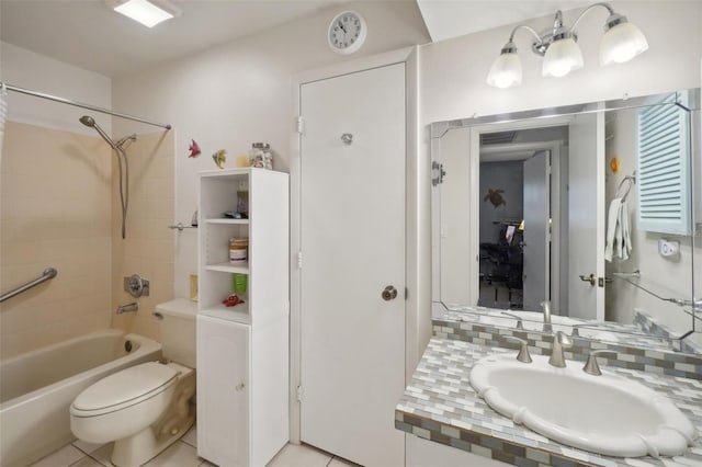 full bathroom featuring tiled shower / bath, vanity, toilet, and tile patterned flooring