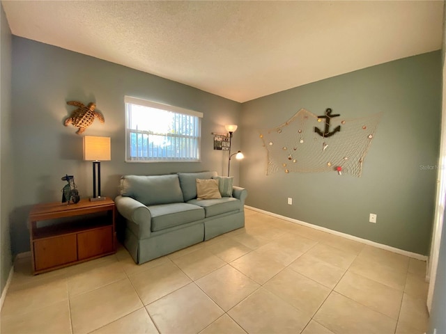 living room with a textured ceiling and light tile patterned floors