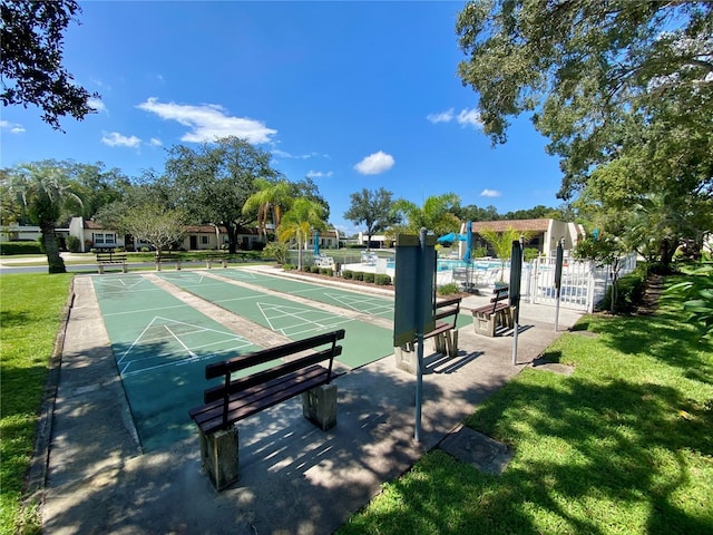 view of property's community with a lawn