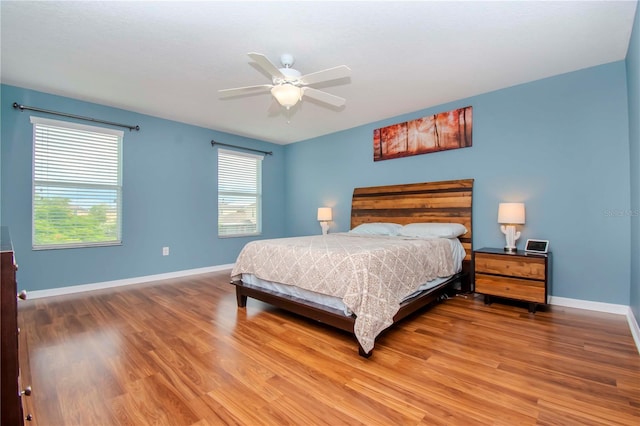 bedroom with hardwood / wood-style floors and ceiling fan