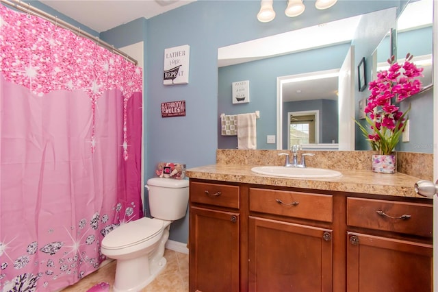 bathroom featuring vanity, toilet, tile patterned floors, and walk in shower