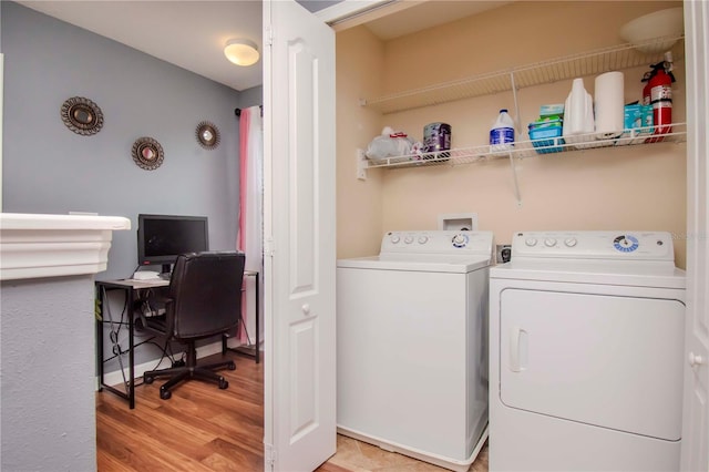 washroom featuring washer and dryer and light hardwood / wood-style flooring