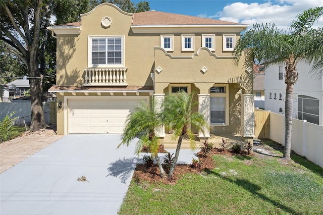 mediterranean / spanish house with a front lawn and a garage