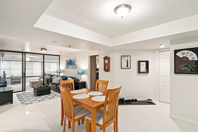 dining space with expansive windows and light tile patterned flooring