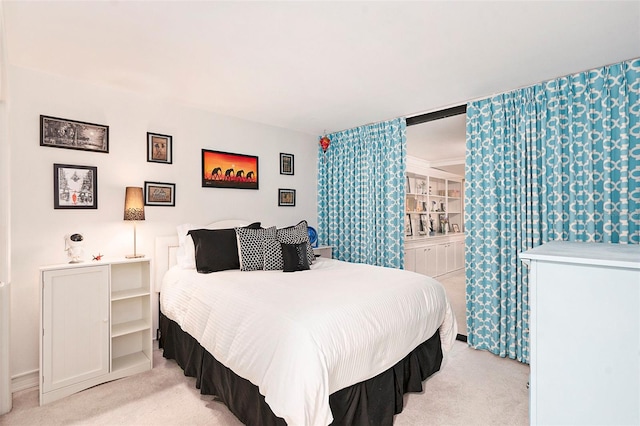 bedroom featuring light colored carpet