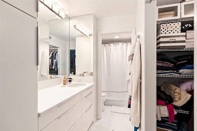 bathroom featuring a shower with shower curtain, tile patterned flooring, toilet, and vanity