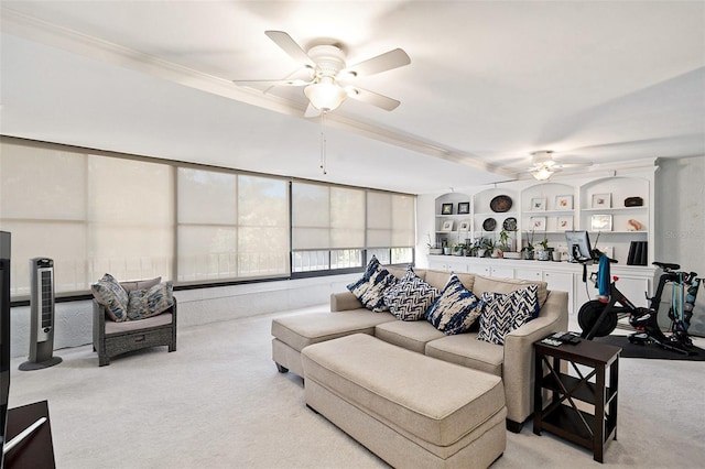 carpeted living room with ceiling fan and ornamental molding