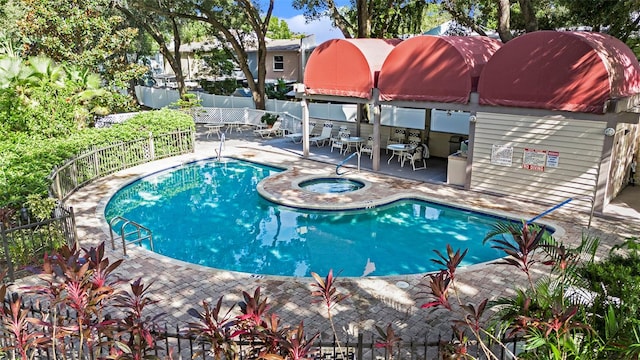 view of swimming pool with a community hot tub and a patio area