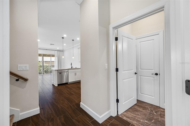 corridor featuring dark hardwood / wood-style flooring and sink