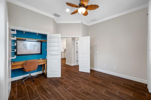 unfurnished office featuring ceiling fan, built in desk, dark hardwood / wood-style floors, and crown molding