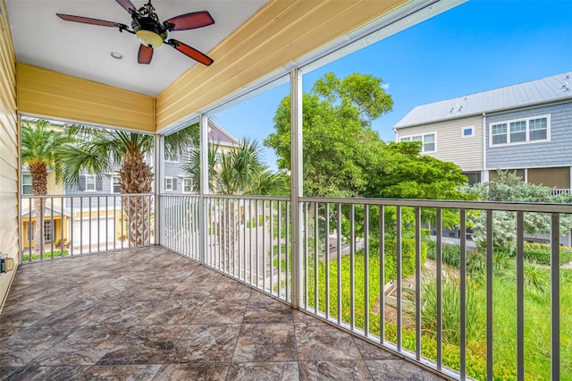 unfurnished sunroom featuring ceiling fan