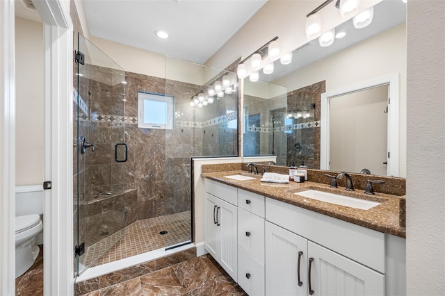 bathroom with vanity, toilet, and an enclosed shower