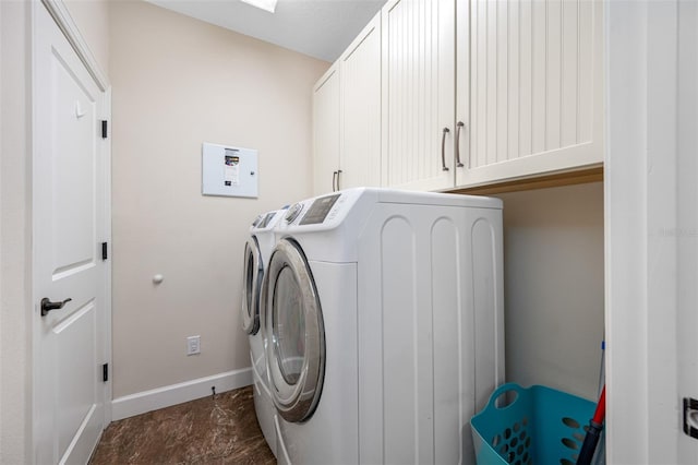 laundry room with washer and clothes dryer and cabinets