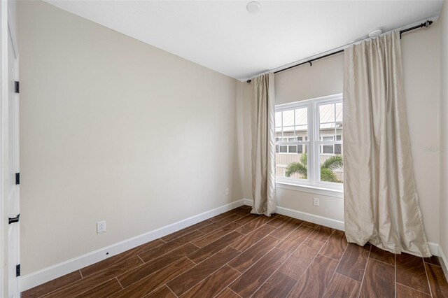 empty room featuring dark wood-type flooring